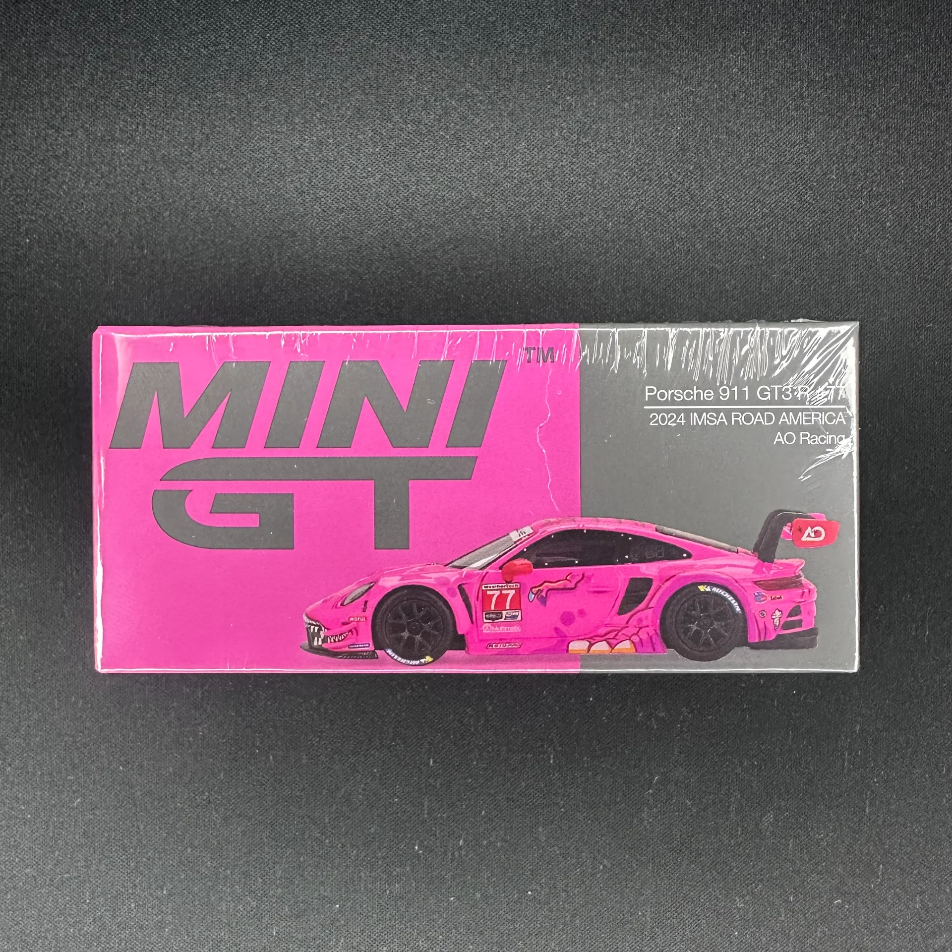 MINI GT #1052 Rexy Porsche 911 GT3 R #77 2024 IMSA ROAD AMERICA AO Racing